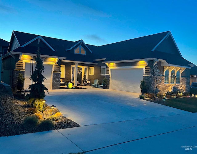 6087 S Pioneer Trail Way, Meridian, ID 83642 - craftsman inspired home featuring stone siding, concrete driveway, and an attached garage