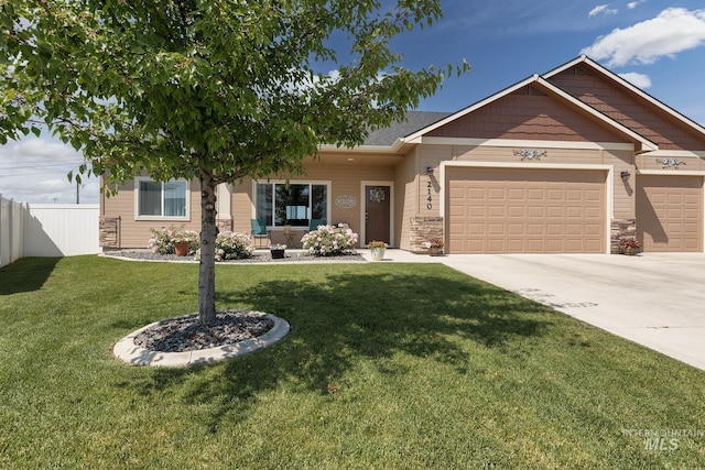 2140 Lisa Ct, Payette, ID 83661 - view of front of home featuring a garage, concrete driveway, and stone siding
