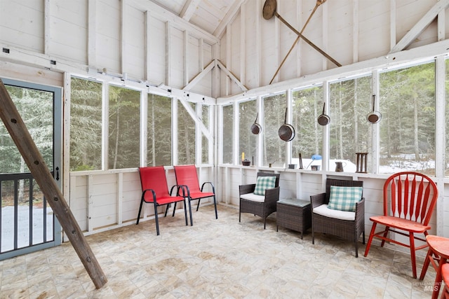 sunroom / solarium featuring vaulted ceiling