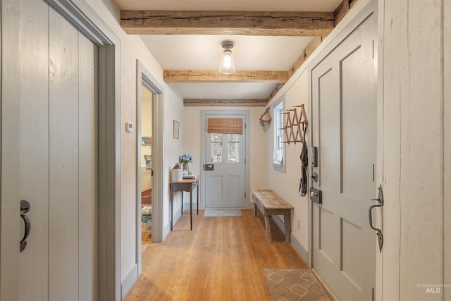 entryway with beamed ceiling and light hardwood / wood-style flooring