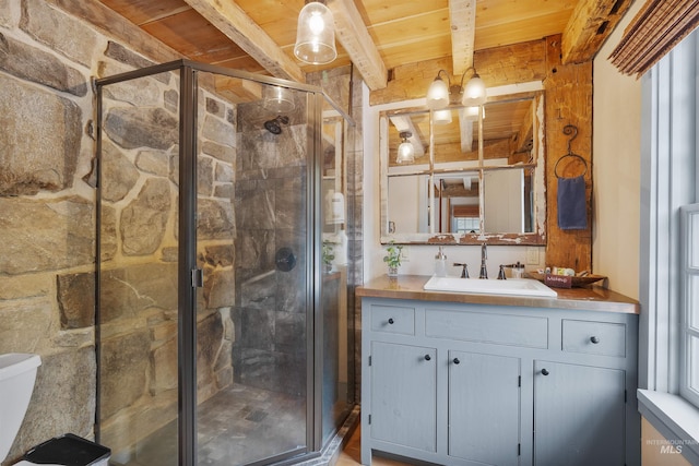 bathroom with a shower with shower door, beam ceiling, wooden ceiling, and vanity