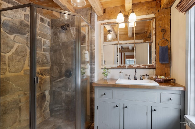 bathroom featuring vanity, beam ceiling, a shower with shower door, and wooden ceiling