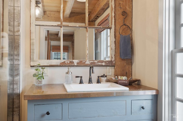 bathroom featuring beamed ceiling, vanity, and wood ceiling