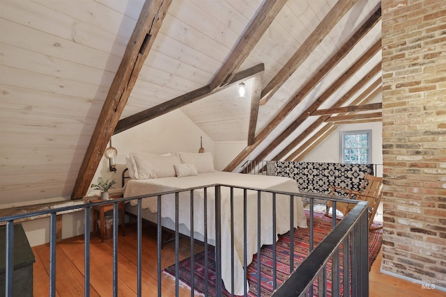 staircase featuring lofted ceiling with beams, wood-type flooring, and wooden ceiling