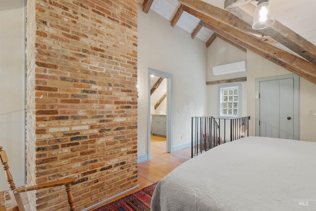 bedroom with ceiling fan, lofted ceiling with beams, brick wall, an AC wall unit, and light hardwood / wood-style floors