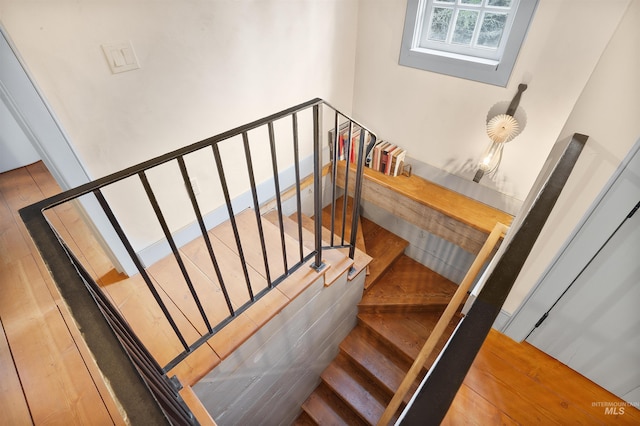 stairs featuring hardwood / wood-style floors