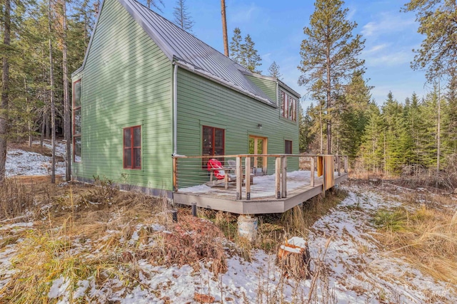 rear view of property featuring a wooden deck