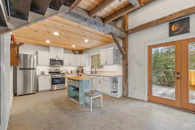 kitchen featuring wood counters, white cabinetry, stainless steel appliances, and wooden ceiling