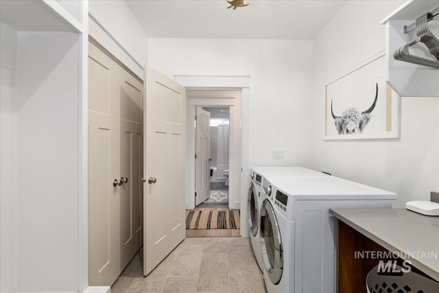 clothes washing area featuring washing machine and clothes dryer