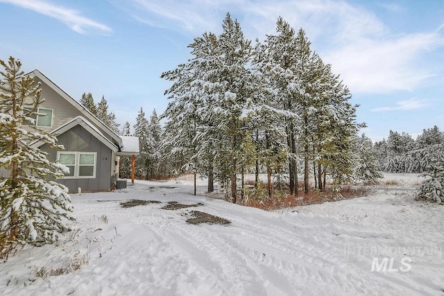 yard covered in snow with central AC unit