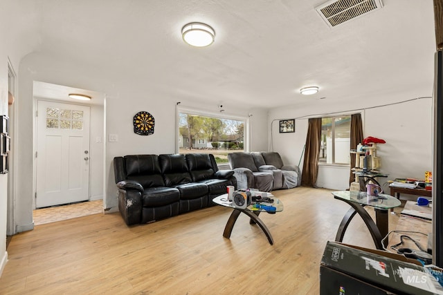 living room featuring visible vents and light wood-type flooring
