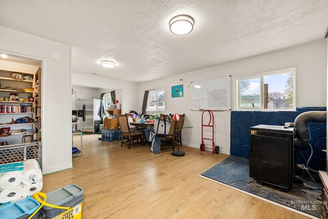 office space with a textured ceiling, wood finished floors, and a wealth of natural light