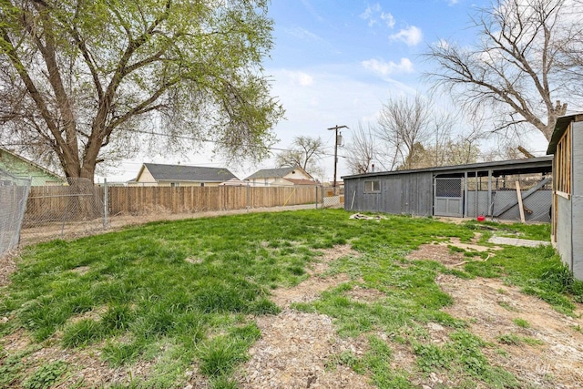view of yard featuring an outdoor structure and fence