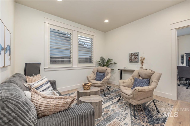 living area with hardwood / wood-style floors