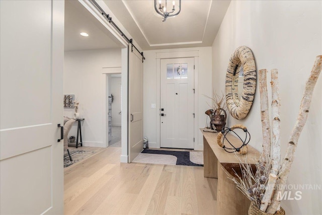 entrance foyer featuring light hardwood / wood-style floors and a barn door