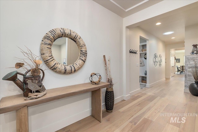 hallway with light hardwood / wood-style flooring