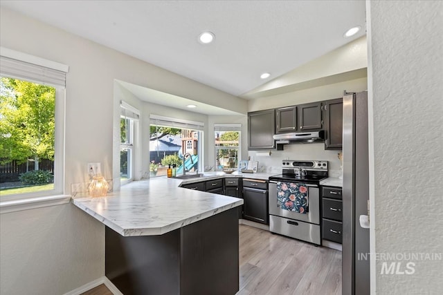 1722 W Mcglinchey St, Meridian, ID 83646 - kitchen with appliances with stainless steel finishes, under cabinet range hood, a peninsula, light countertops, and light wood-style flooring