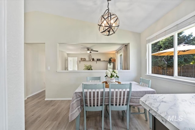 1722 W Mcglinchey St, Meridian, ID 83646 - dining area featuring lofted ceiling, light wood-type flooring, a chandelier, and a ceiling fan