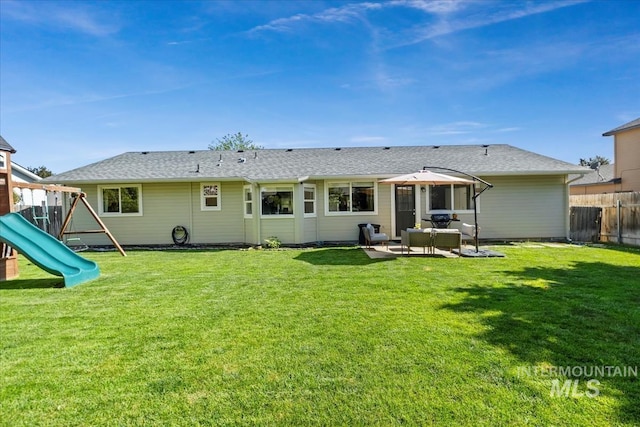 1722 W Mcglinchey St, Meridian, ID 83646 - back of house with a playground, a patio, and a shingled roof