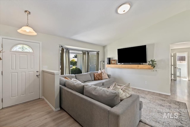 1722 W Mcglinchey St, Meridian, ID 83646 - living room featuring lofted ceiling, healthy amount of natural light, and light wood finished floors