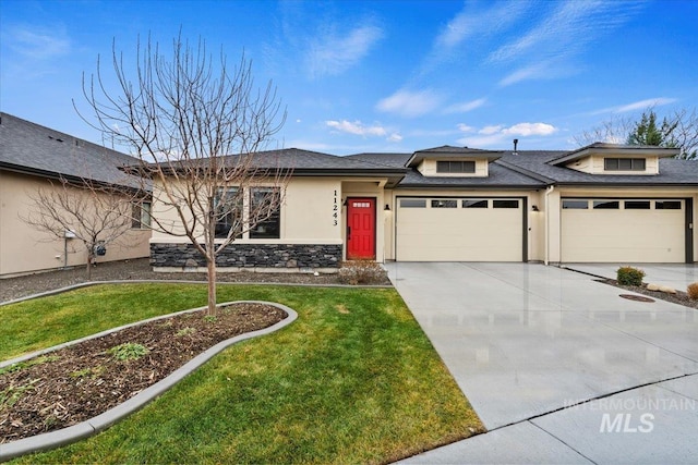 prairie-style home with a front yard and a garage