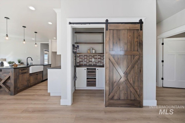 pantry featuring beverage cooler and a sink