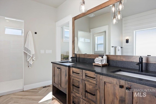 full bathroom featuring a walk in shower, visible vents, a sink, and double vanity