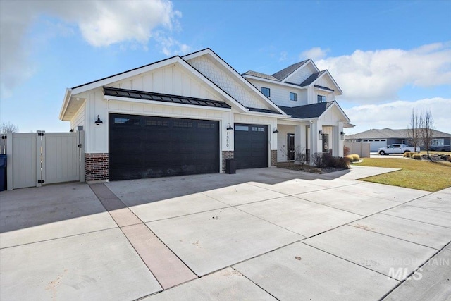 view of front of house featuring brick siding, concrete driveway, a standing seam roof, a gate, and a garage