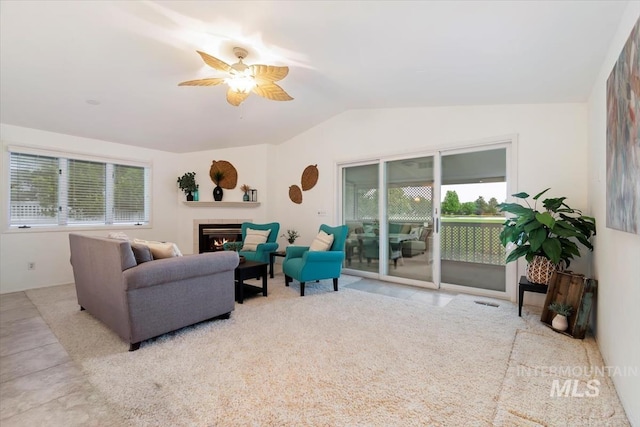 1411 E Medinah Ct, Eagle, ID 83616 - living room featuring vaulted ceiling, healthy amount of natural light, ceiling fan, and a tile fireplace