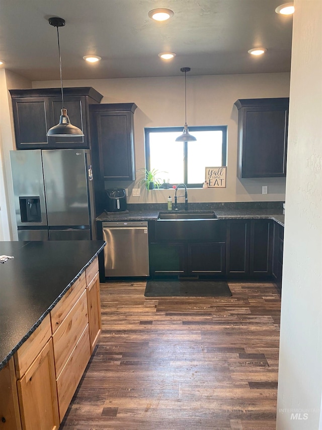 kitchen with pendant lighting, stainless steel appliances, dark hardwood / wood-style flooring, and sink