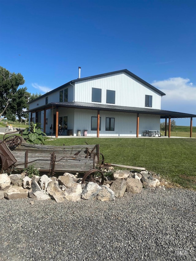 back of house with a lawn