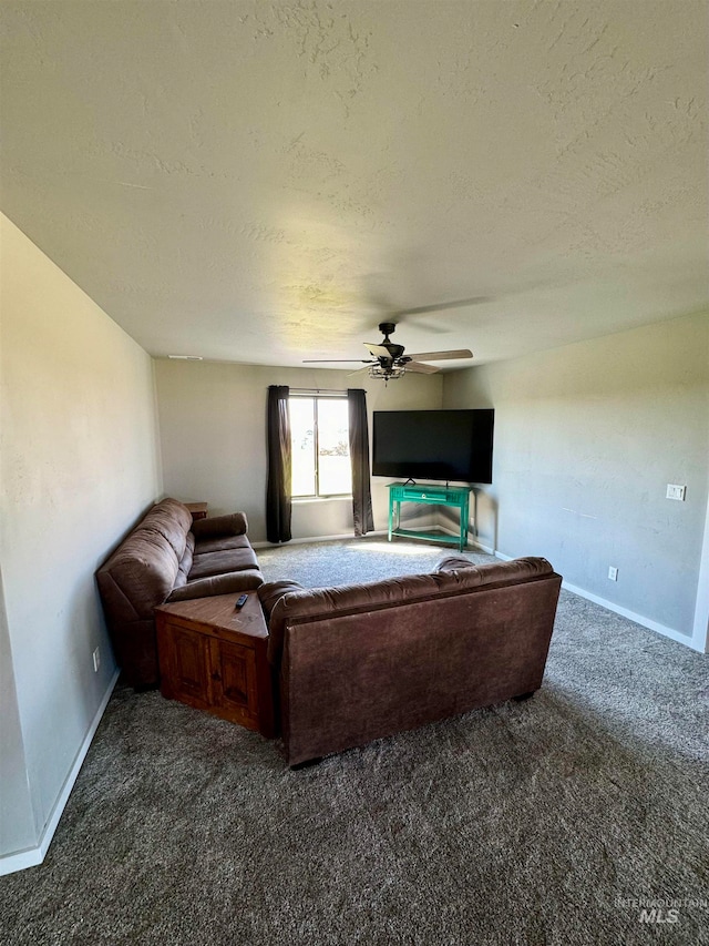 living room with carpet flooring, ceiling fan, and a textured ceiling