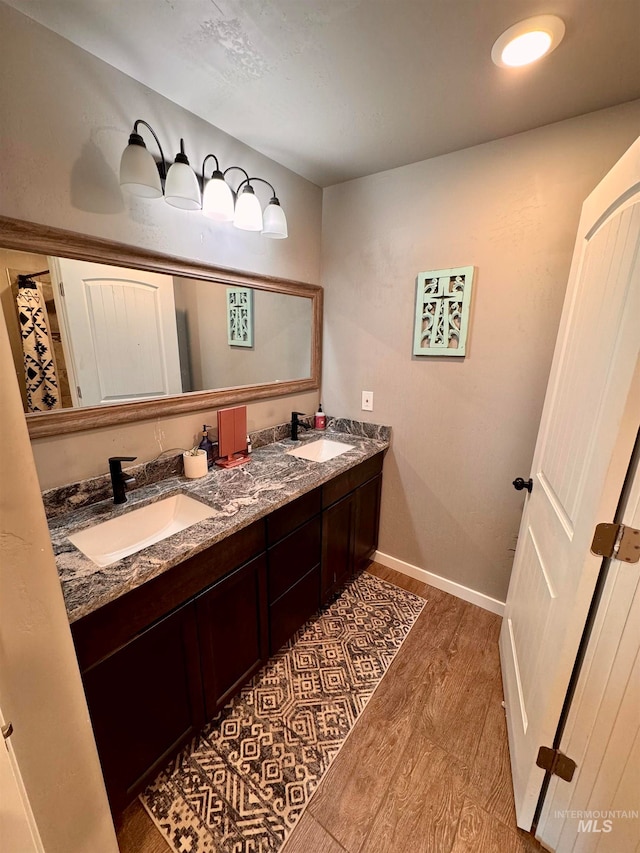 bathroom featuring vanity and wood-type flooring