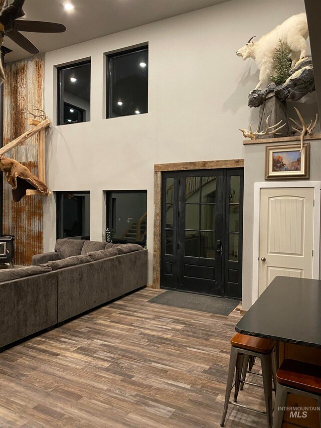 living room featuring ceiling fan and dark hardwood / wood-style floors