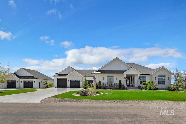 view of front of home with a garage, covered porch, and a front yard