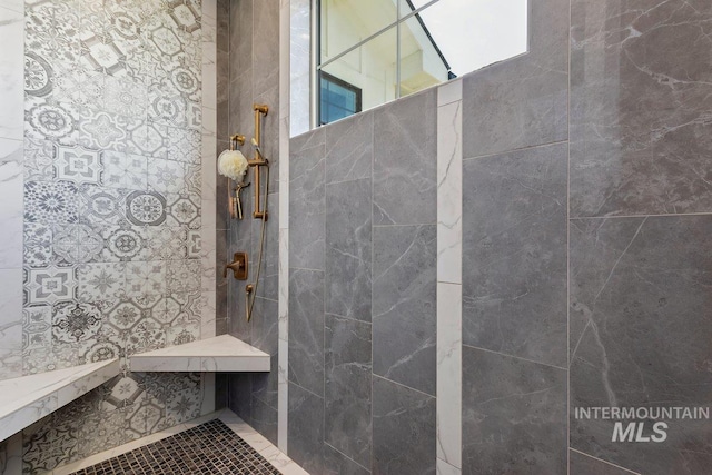 bathroom with tiled shower