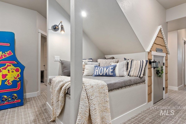 carpeted bedroom with vaulted ceiling