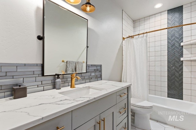 full bathroom with shower / bath combo, backsplash, vanity, tile patterned flooring, and toilet