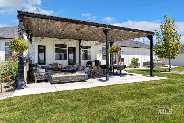 view of patio / terrace with a hot tub and a fire pit