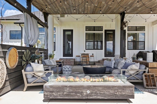 view of patio / terrace with an outdoor living space with a fire pit