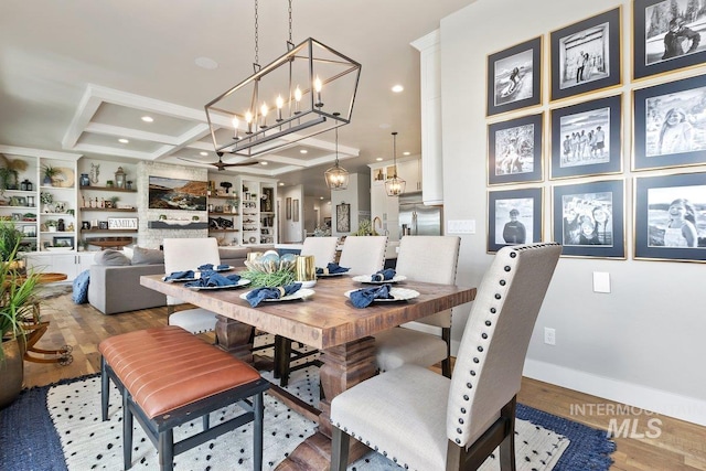 dining area with coffered ceiling, built in features, beamed ceiling, a notable chandelier, and wood-type flooring