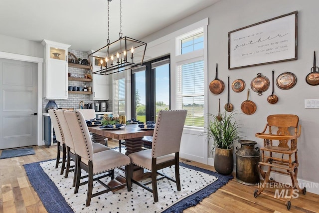 dining room featuring a chandelier and light wood-type flooring