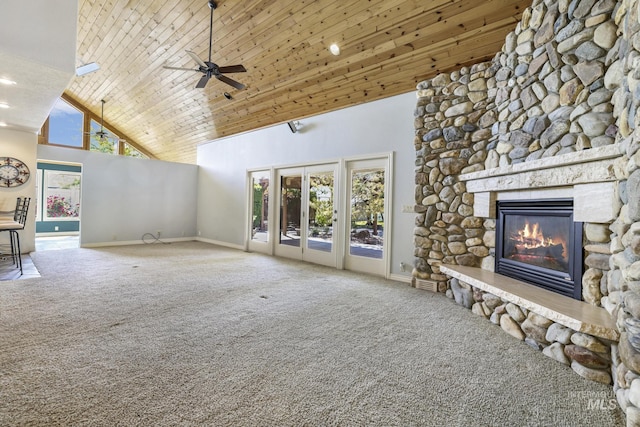 70 Pelican Dr, Rupert, ID 83350 - unfurnished living room with high vaulted ceiling, carpet flooring, baseboards, a stone fireplace, and healthy amount of natural light