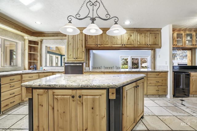 70 Pelican Dr, Rupert, ID 83350 - kitchen with a sink, a kitchen island, wine cooler, a textured ceiling, and stone tile floors