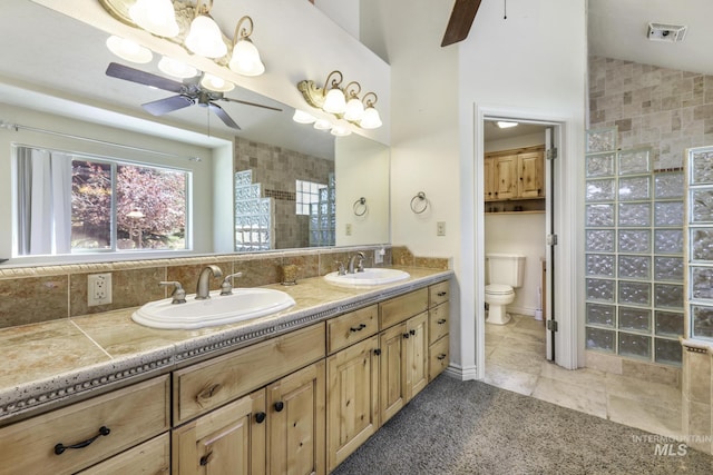 70 Pelican Dr, Rupert, ID 83350 - full bath featuring ceiling fan, walk in shower, lofted ceiling, toilet, and double vanity