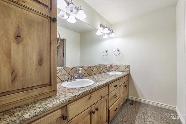 70 Pelican Dr, Rupert, ID 83350 - bathroom featuring backsplash, baseboards, and double vanity