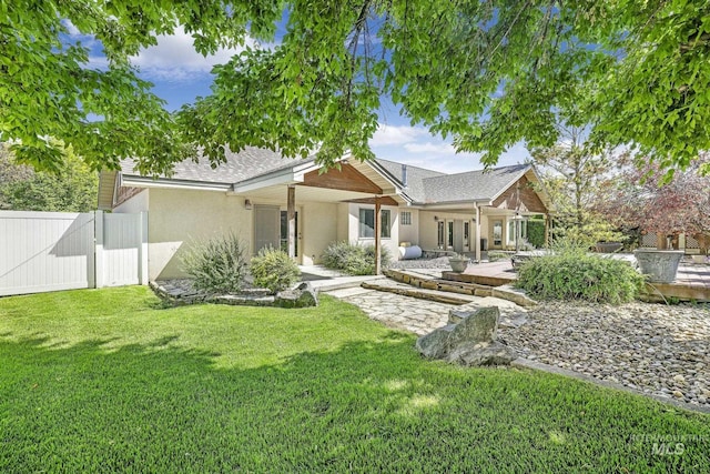 70 Pelican Dr, Rupert, ID 83350 - back of house with stucco siding, a gate, roof with shingles, and a patio