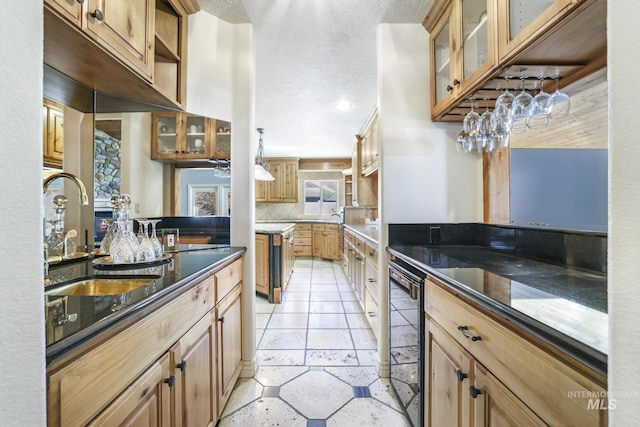 70 Pelican Dr, Rupert, ID 83350 - kitchen with glass insert cabinets, a sink, beverage cooler, and dark stone countertops