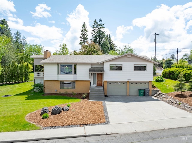 1205 Ponderosa Dr, Moscow, ID 83843 - raised ranch with an attached garage, driveway, brick siding, a chimney, and a front lawn
