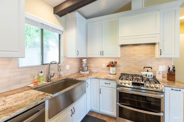1205 Ponderosa Dr, Moscow, ID 83843 - kitchen featuring stainless steel appliances, a sink, beamed ceiling, white cabinetry, and tasteful backsplash